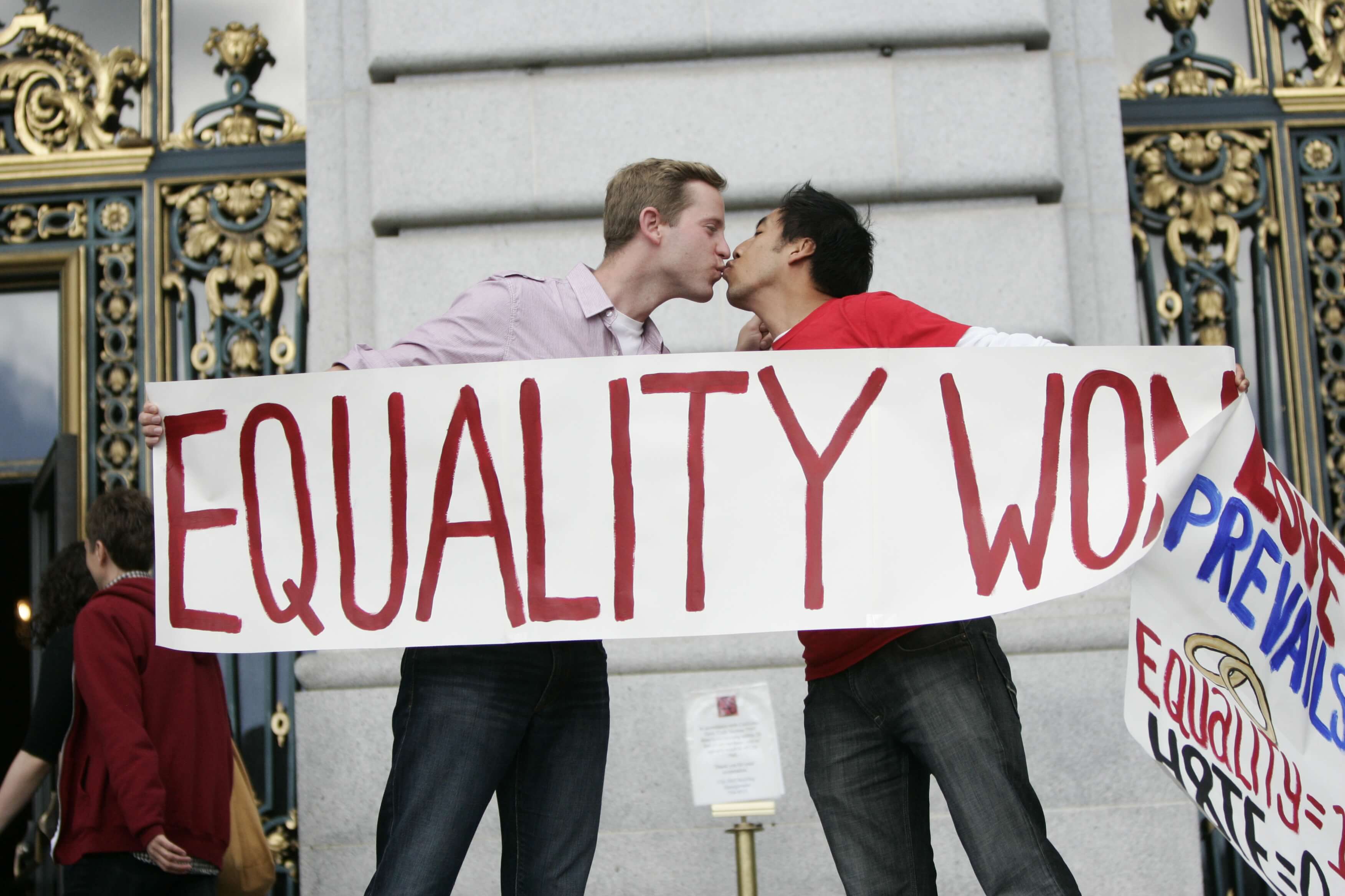 A gay couple shares a kiss celebrating the 2013 Supreme Court ruling striking down DOMA.